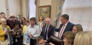 Governor Meyer signs the Ron Silverio/Heather Block Delaware End-of-Life Options Act into law surrounded by advocates and legislative champions on May 20.